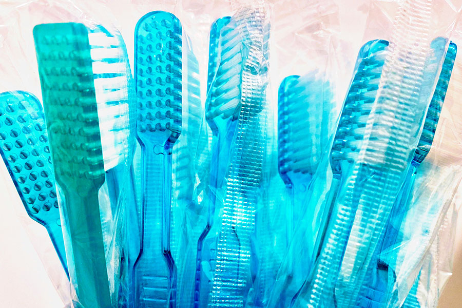 Blue toothbrushes in a cup.